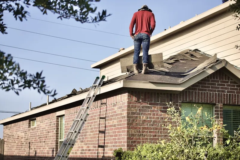 Professional roofer working on a residential roof in Kings Grant